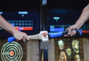 Marysville axe throwing men tap axes together